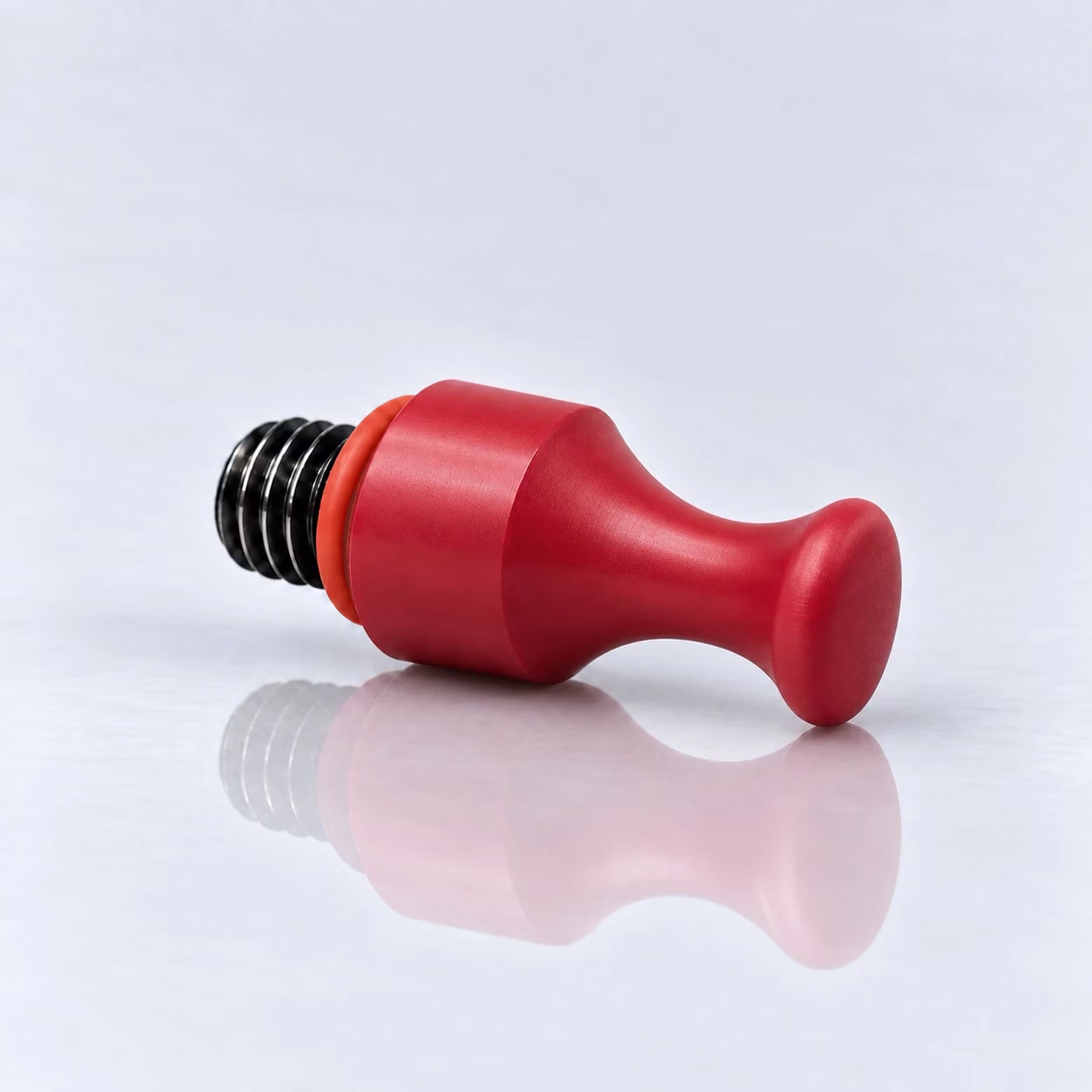 Wechselspitze Mittel Hart – rote Wechselspitze aus hartem Kunststoff mit schwarzem Gewinde und orange-rotem O-Ring, liegend